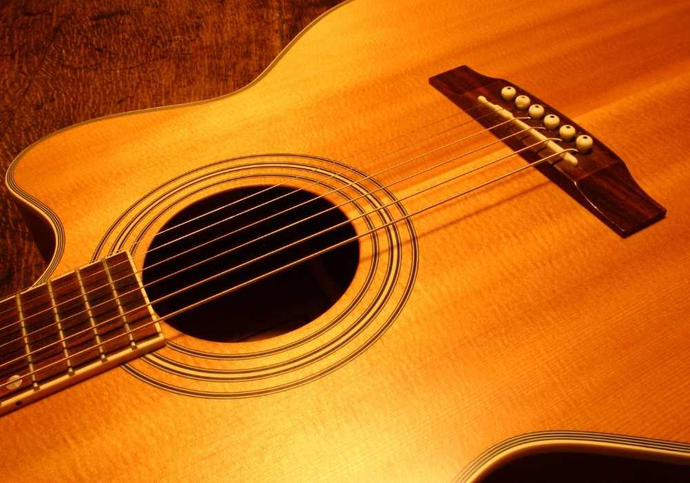 A close-up body of an acoustic guitar.