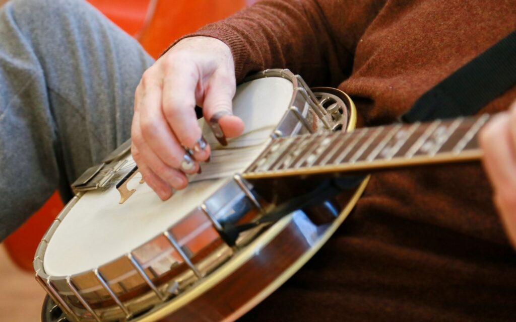 A musician playing a clawhammer banjo