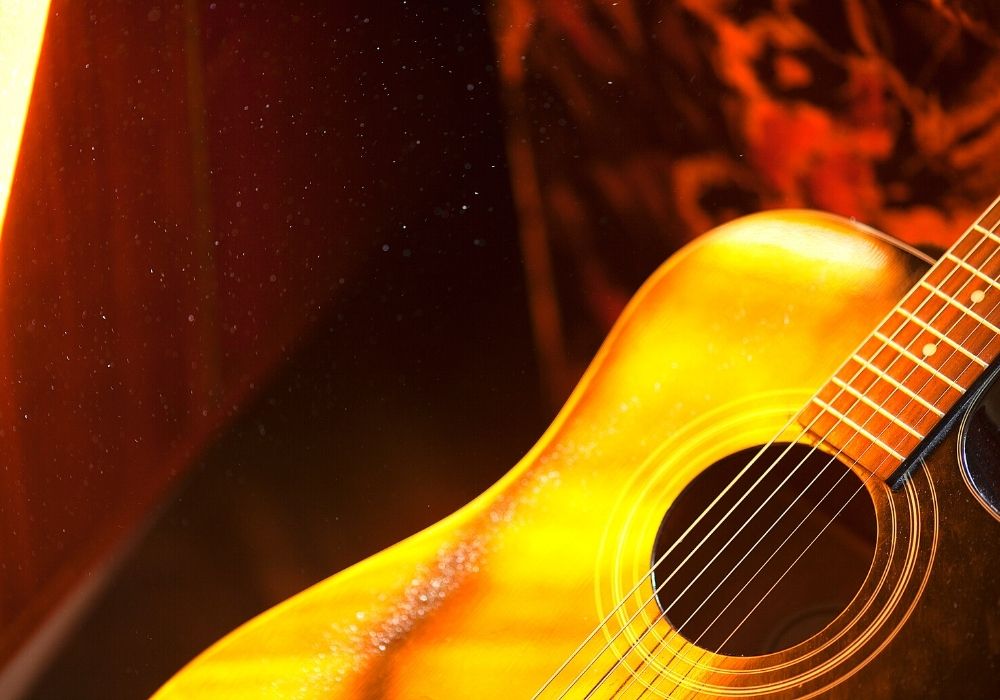 A semi-acoustic guitar close-up in a bright color background