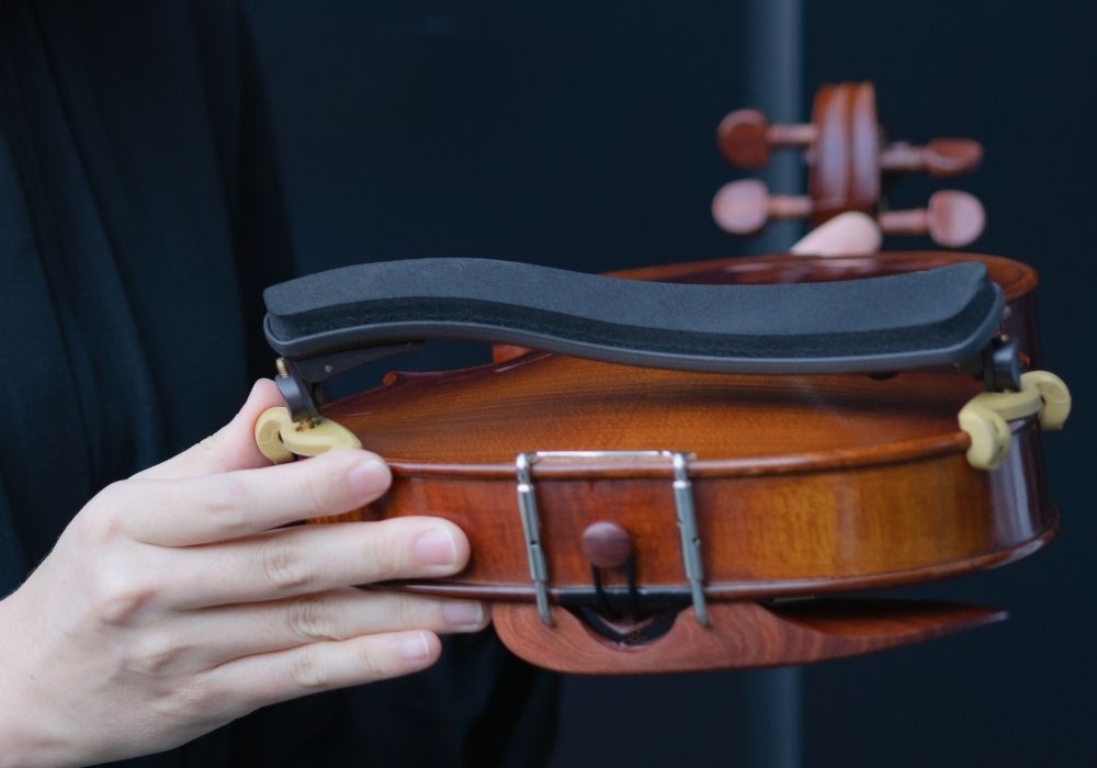 A violinist showing a violin shoulder rest
