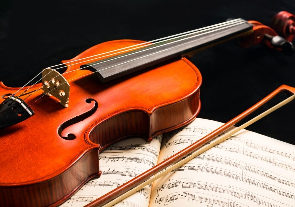 An intermediate violin and a music book