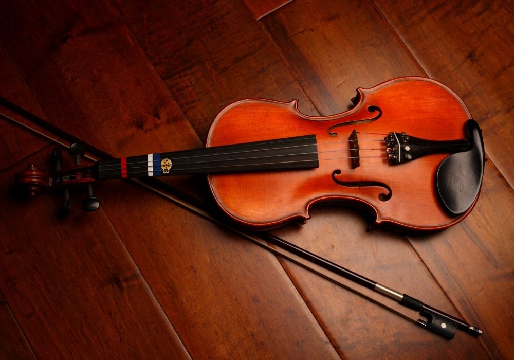 An up-close of a beginner violin on the floor
