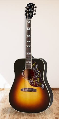 Gibson Hummingbird Standard WOODEN floor with white wall as background