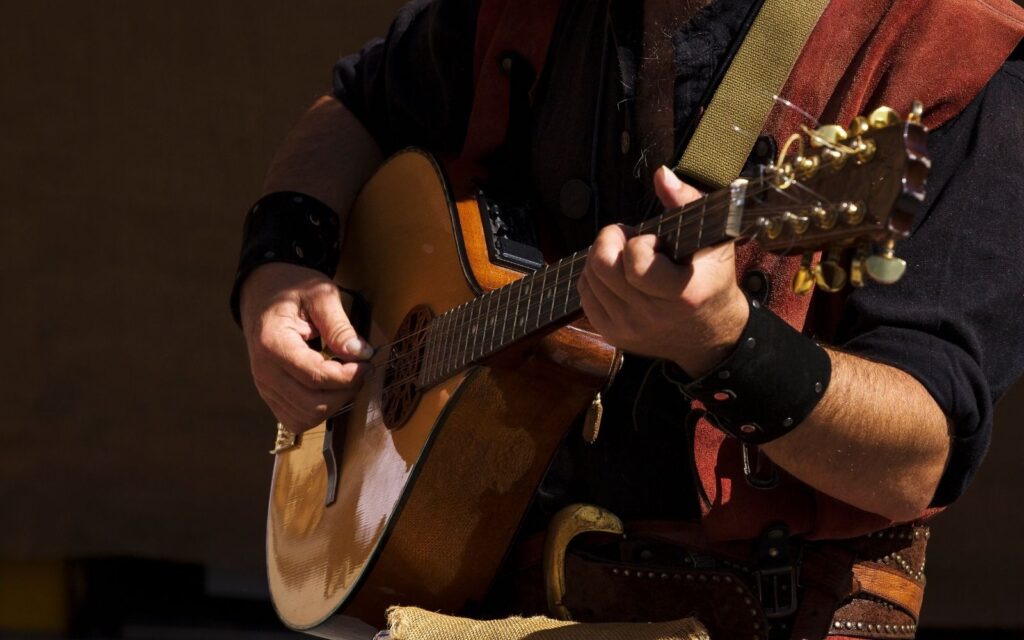 close up hands hipster man playing mandolin