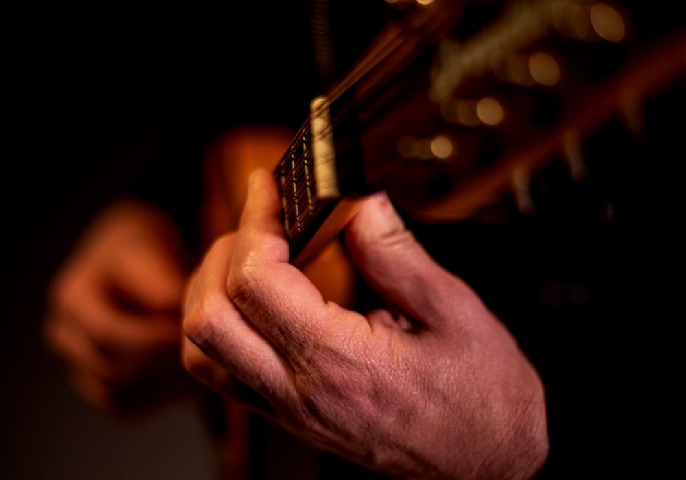 close up hands of a man playing mandolin