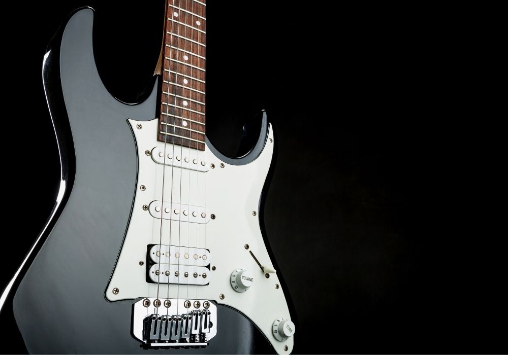 close up of an electric guitar on a dark background