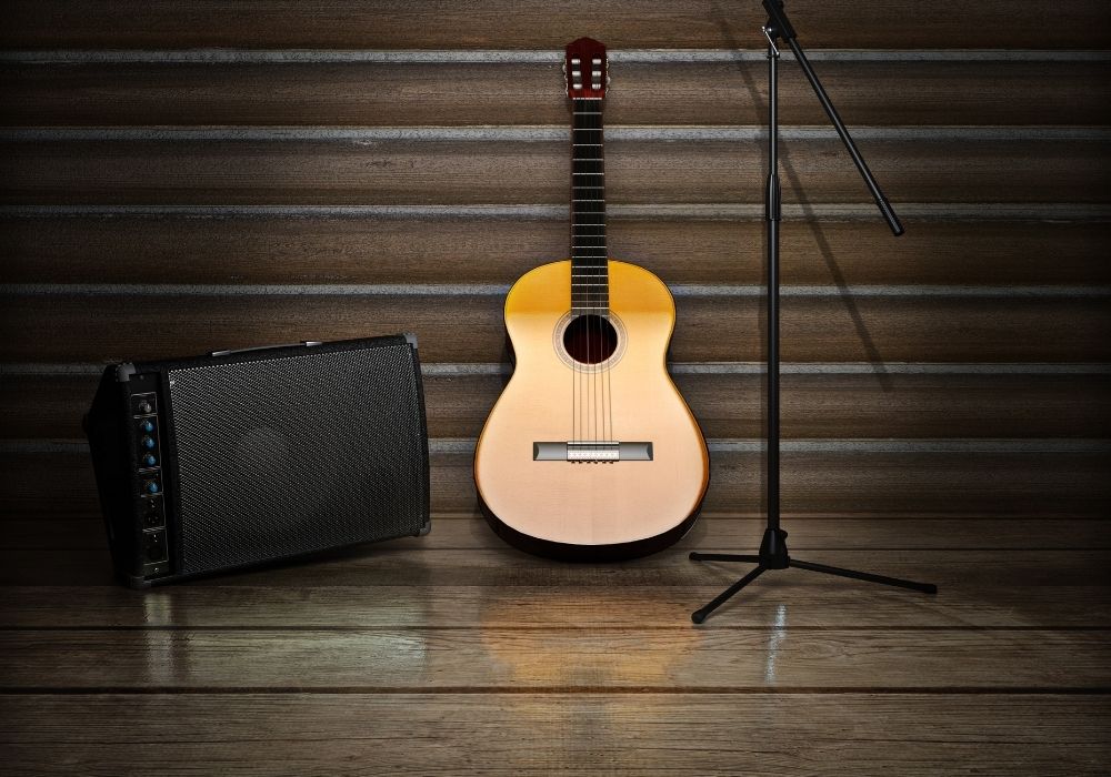 Music themed background with acoustic guitar and acoustic guitar amp