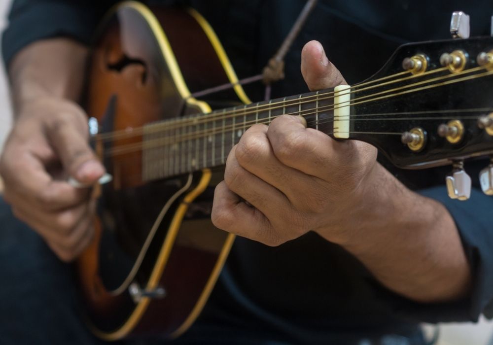 a musician playing his electric mandolin