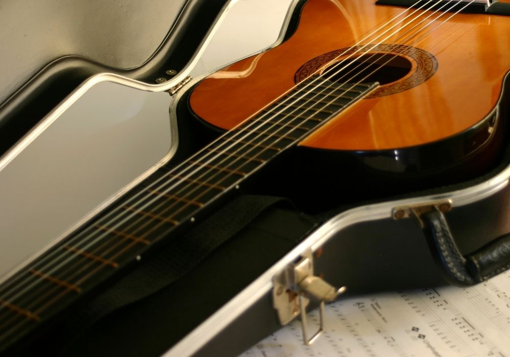 acoustic guitar inside the guitar case for flying