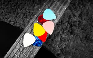 acoustic guitar picks on a dark background