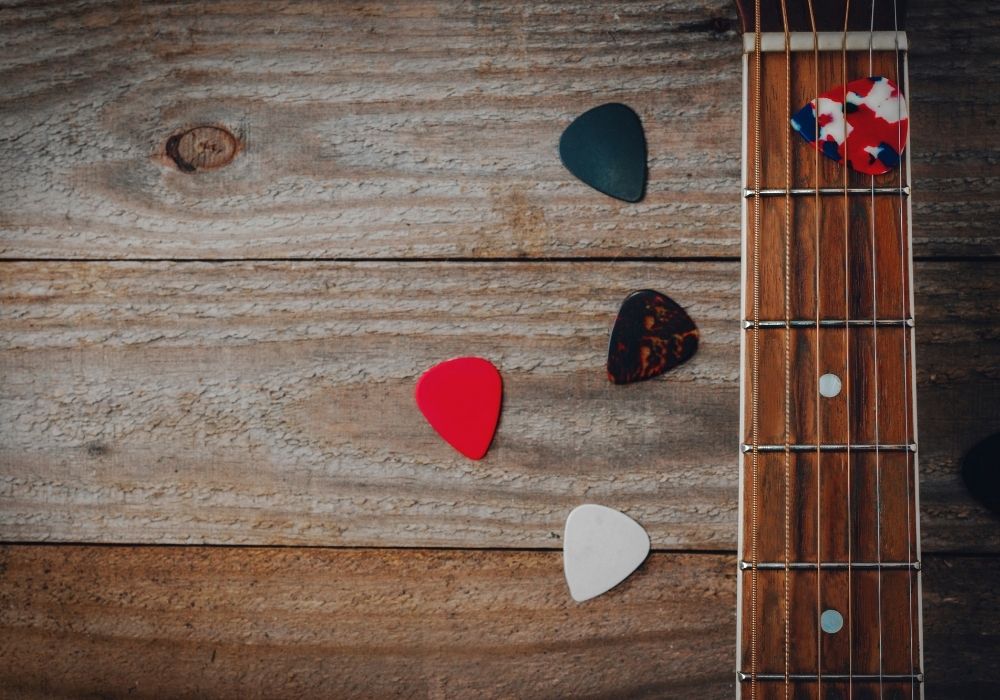 acoustic guitar picks on a variety of colors