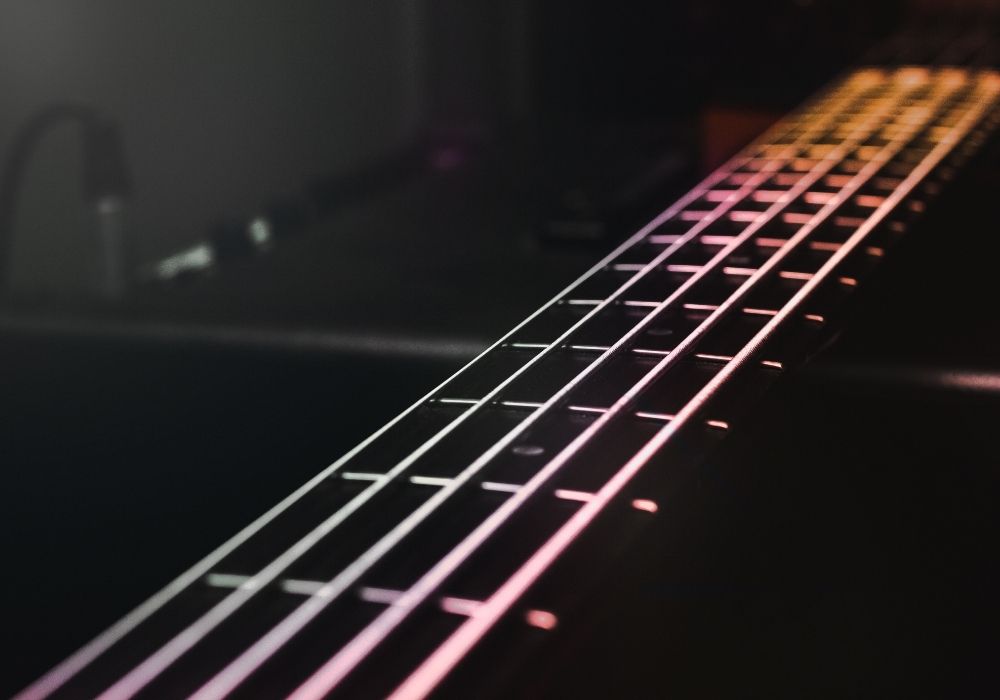 close up of a bass guitar strings and frets