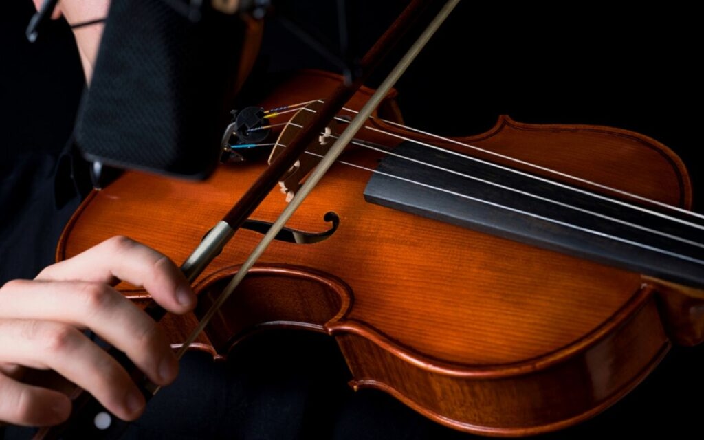 musician plays viola in a recording Studio