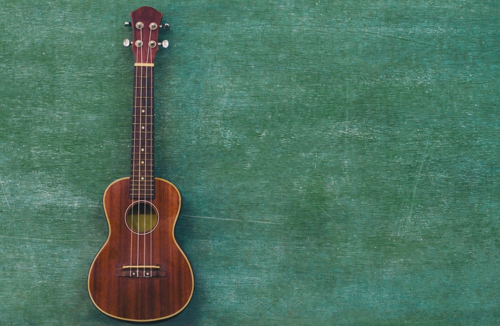 baritone ukulele with a green background