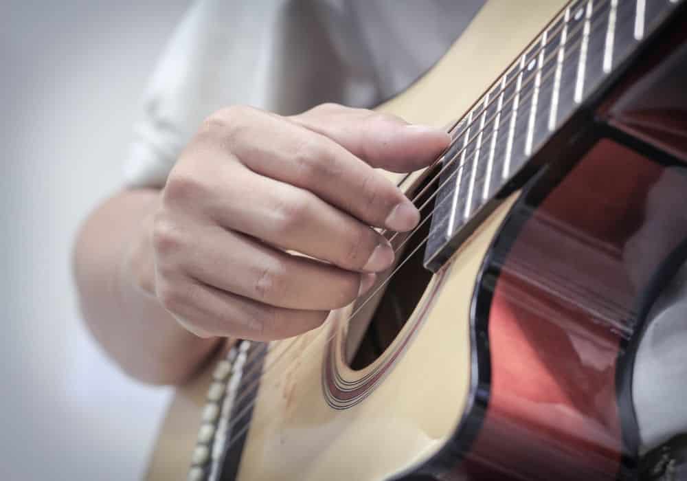 A guitarist strumming his acoustic guitar