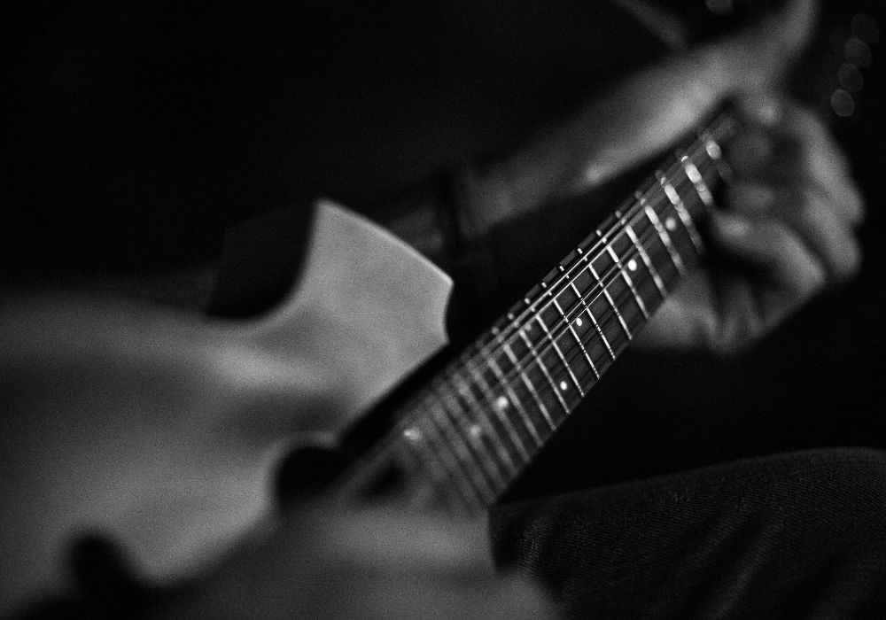a mandolin player strumming an Ibanez M510