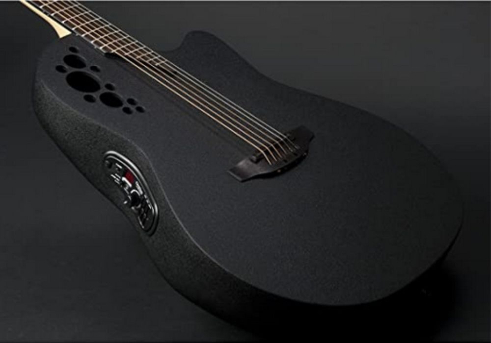 Ovation acoustic guitar in color black on a black background.