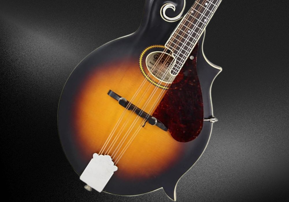 A closer look at Gretsch G9350 mandolin on a black background.